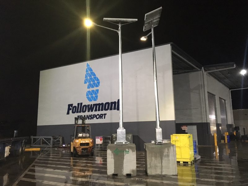 Portable solar lighting towers at a transport depot